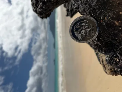 Challenge coin on the beaches of Hawaii for a product photo shoot