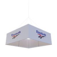 A white and blue Reebok-branded hanging banner displays the company's logo against a plain background.