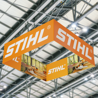 A hanging square display with the 'STIHL' logo, suspended in a trade show hall, advertises brand presence.