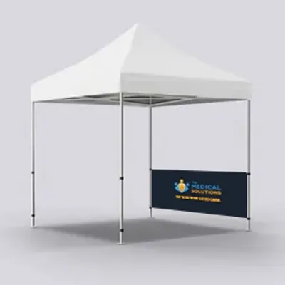 Half Right Wall Single Sided A white canopy tent with a custom printed back wall displaying a blue background, a medical logo, and text reading 'MEDICAL SOLUTIONS COMPANY' on a gray surface.